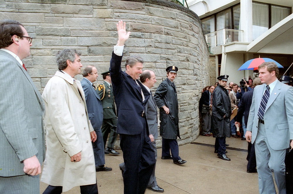 Ronald Reagan survives an assassination attempt by John Hinckley Jr.