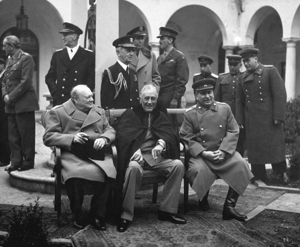 World War II strategy meeting between Allies, Churchill, Stalin, and Roosevelt in Tehran.