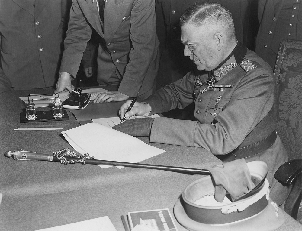 WWII Axis Powers surrender to the Allies under General Eisenhower at Allied headquarters.