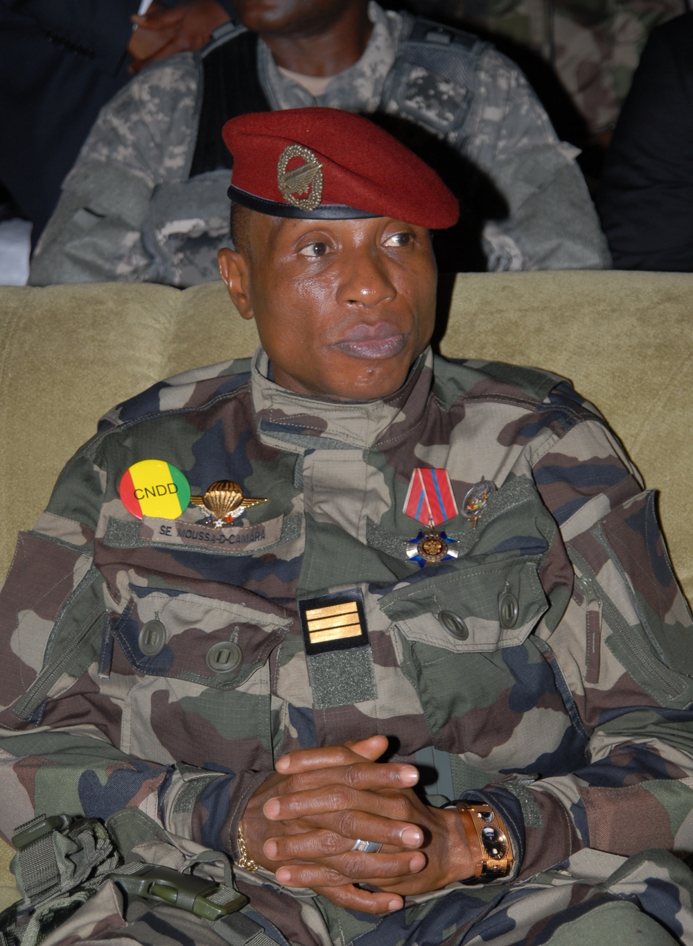 Captain Camara is shot in the head by a former aide.