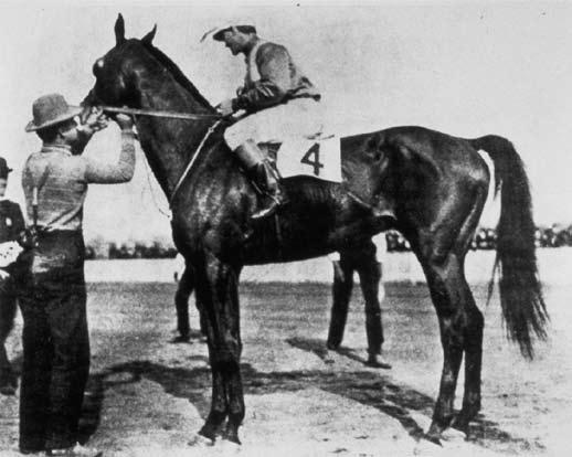 Elwood wins at a fast track with jockey Shorty Prior, trainer Charles Durnell, and owner Laska Durnell.