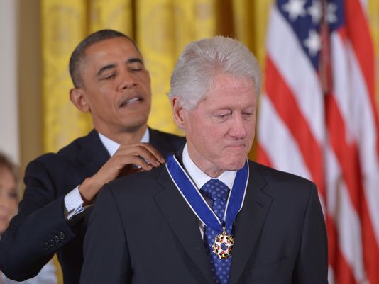 Awarded the Presidential Medal of Freedom: Barack Obama honors Bill Clinton.