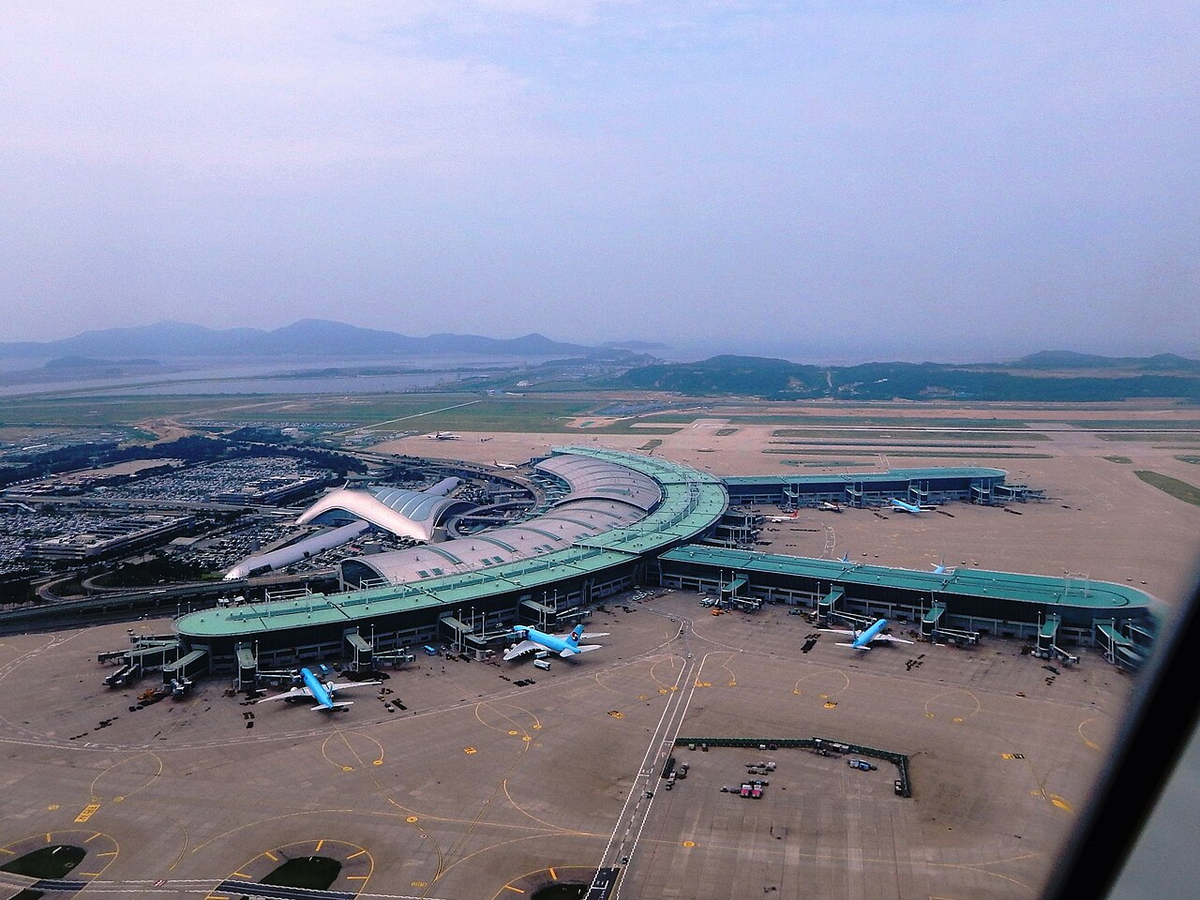 Moment image for Incheon International Airport opening on tidal land off port.
