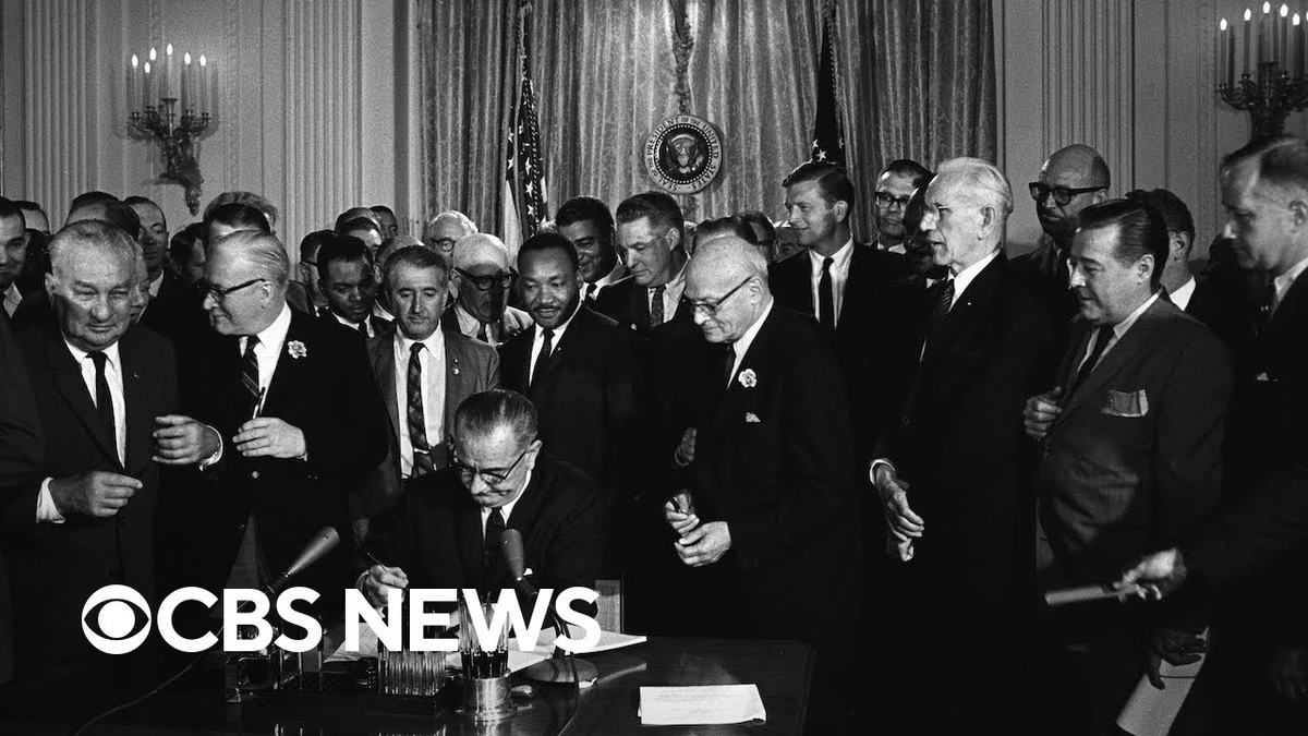 Moment image for Civil Rights Act signed into law by President Lyndon B. Johnson to combat racial discrimination.