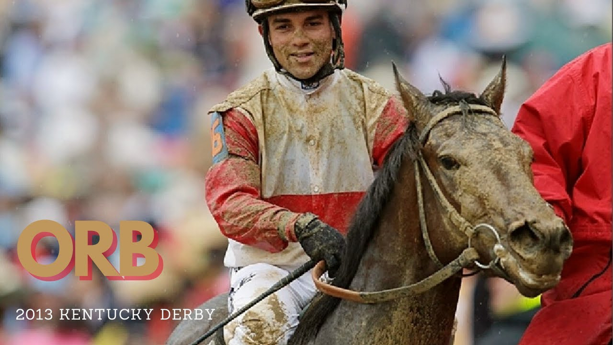 Moment image for Orb wins with Joel Rosario riding in sloppy conditions at 1+1⁄4 miles.