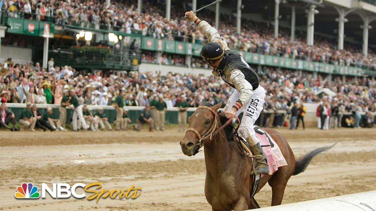Moment image for Fusaichi Pegasus wins with Kent Desormeaux, Neil Drysdale, Fusao Sekiguchi in fast 1+1⁄4-mile race.